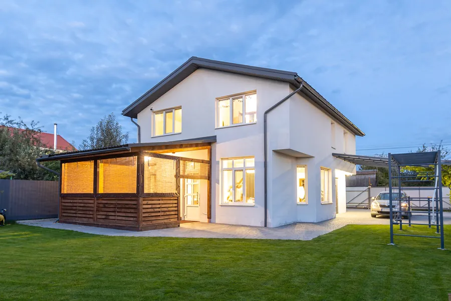 Completed house, with a terrace and landscaped garden, in the evening